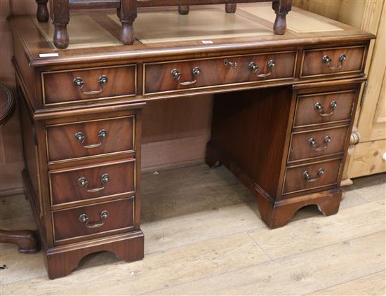 An Abbeycraft mahogany twin pedestal desk with leather top W.122cm